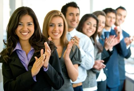 Row of people in business suits clapping