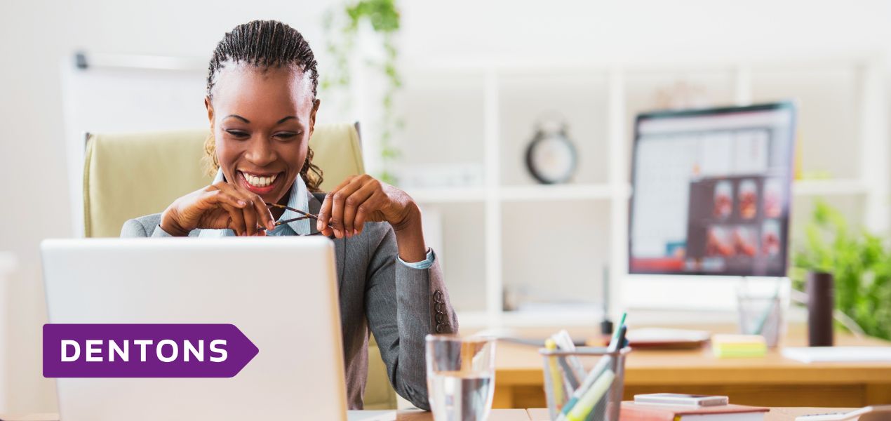 Business woman studying on a laptop in an office.