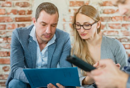 Two colleagues looking at a screen