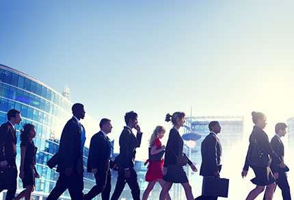 A group of business people walking in the same dir