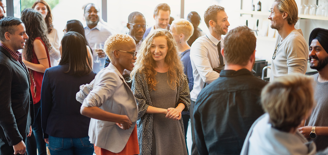Delegates networking at a conference.