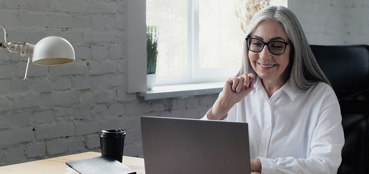 A mature woman using a laptop.