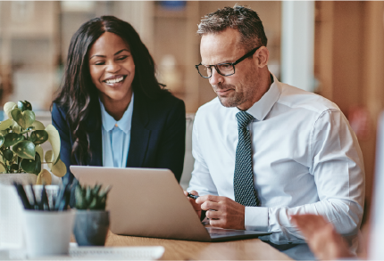 Two colleagues looking at a screen